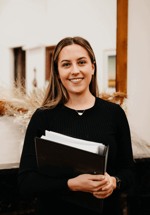 woman holding book in experienced conveyancing office